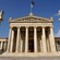 A Greek flag flying over a monumental structure built in the neoclassical style